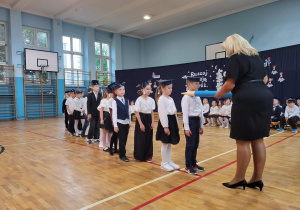 Uroczyste ślubowanie uczniów klas pierwszych_moment pasowania na ucznia szkoły przez Panią Dyrektor Monikę Siedmiogrodzką.